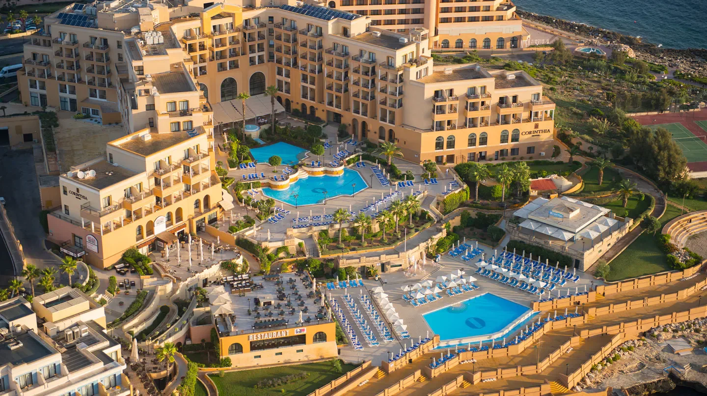 Aerial view of Corinthia St George's Bay hotel with pools in Malta.