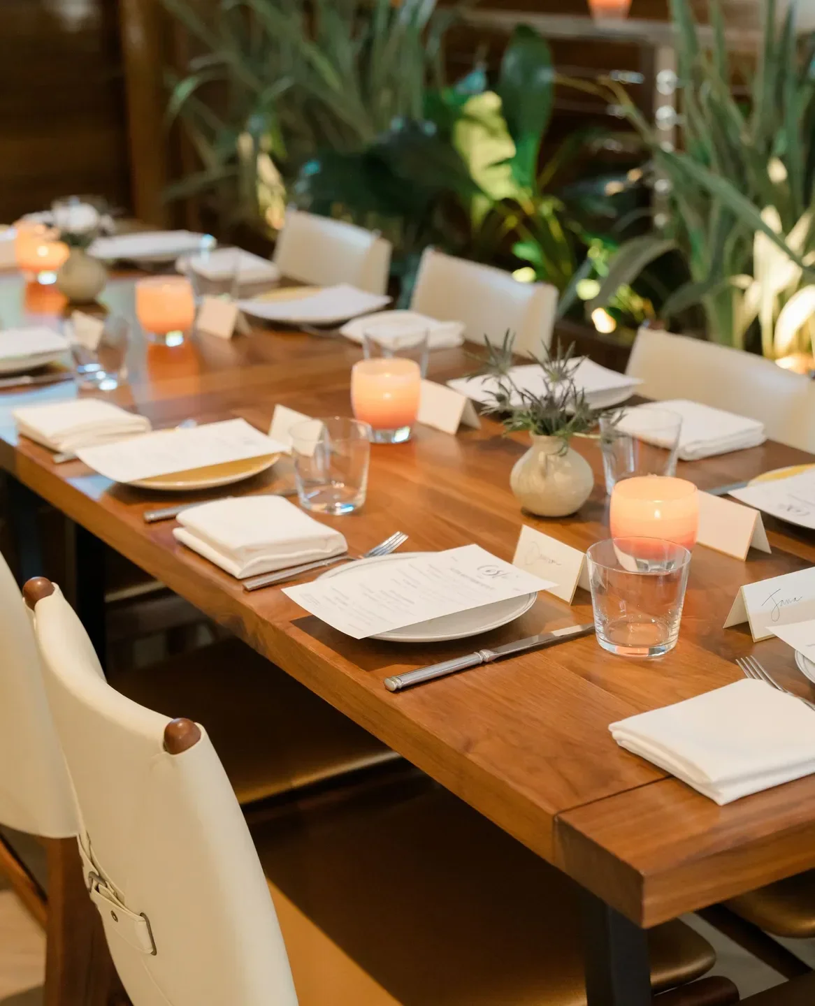Elegant table setting at Costa restaurant in Charleston, featuring candles and place settings.
