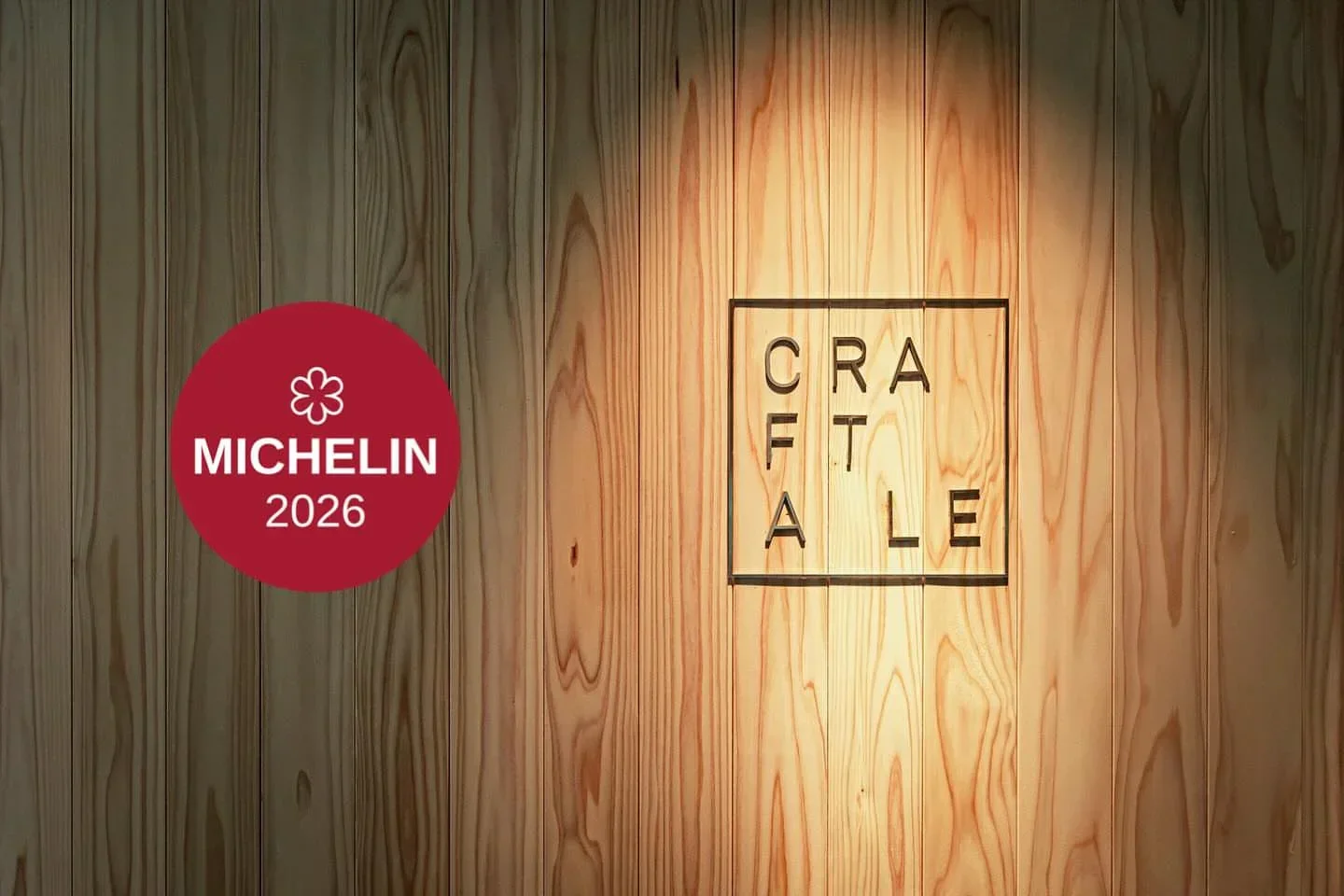 Michelin-recognized Craftale restaurant in Tokyo, showcasing a wooden wall and logo.