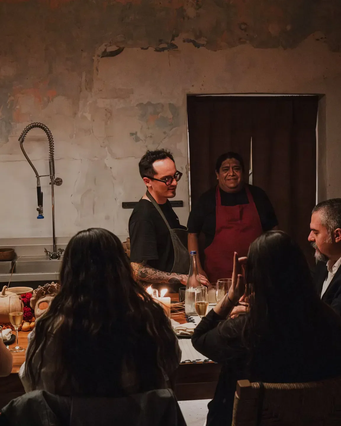 Criollo Oaxaca: Chef and staff at a table with guests. Dining experience.
