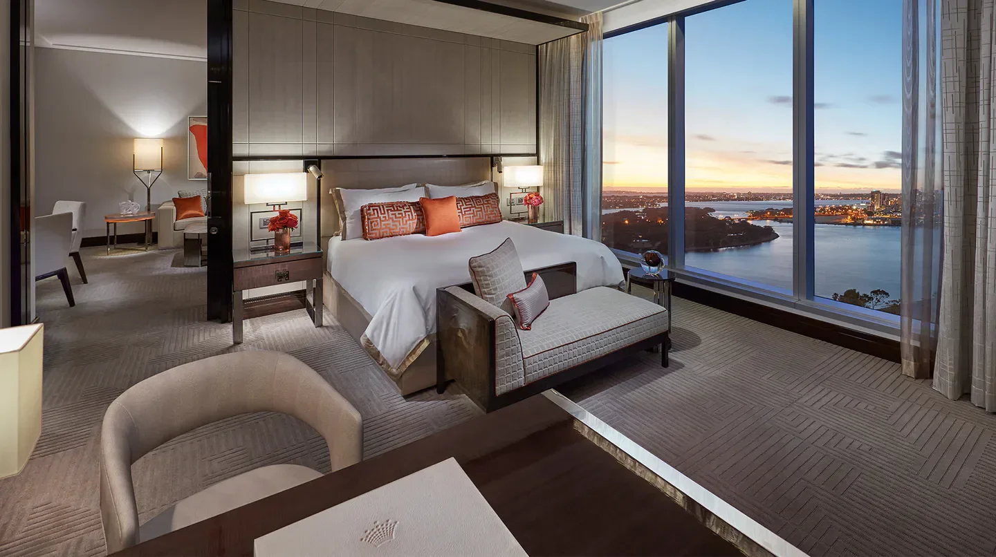 Luxury bedroom with a view at Crown Towers Perth, overlooking Perth at sunset