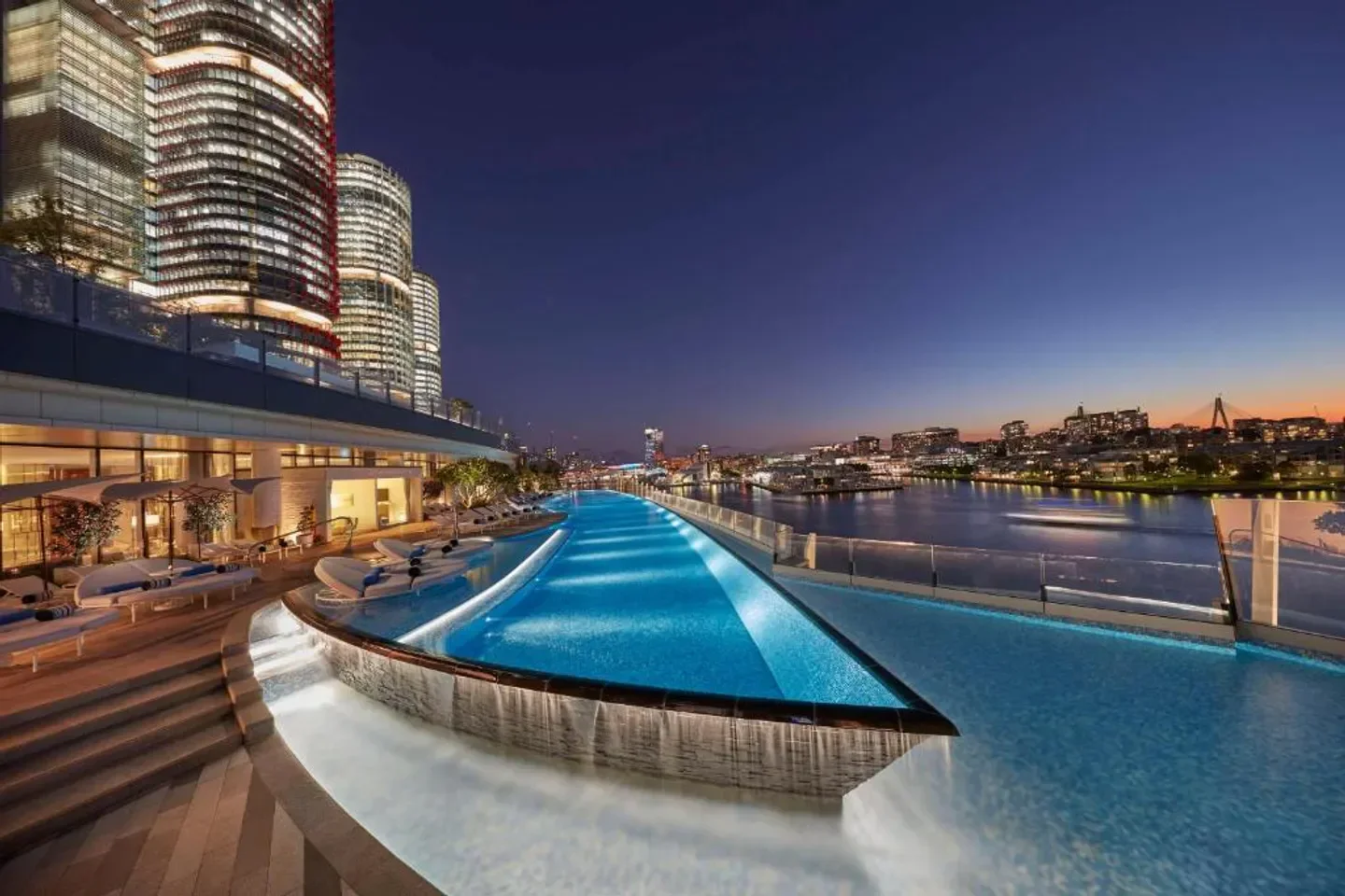 Night view of infinity pool at Crown Towers Sydney, overlooking Sydney Harbour