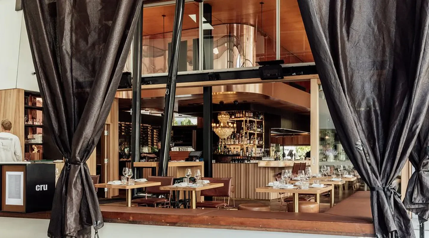 Interior view of Cru Bar & Cellar in Brisbane, with tables and bar