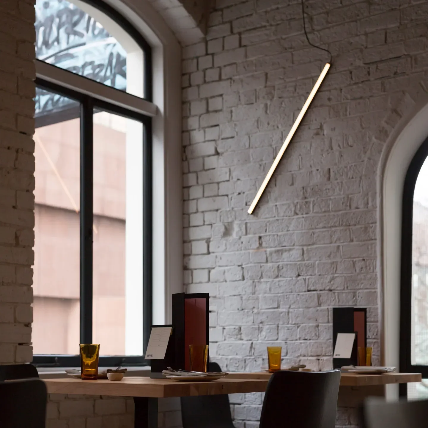 Interior of Culprit restaurant in Auckland, with tables set and modern lighting.