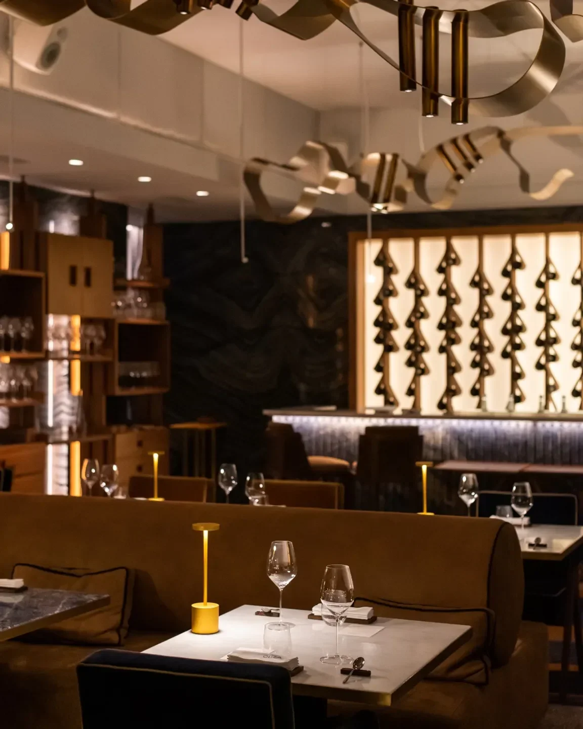 Interior view of CURA restaurant in Lisbon, with elegant dining table setup and decor.