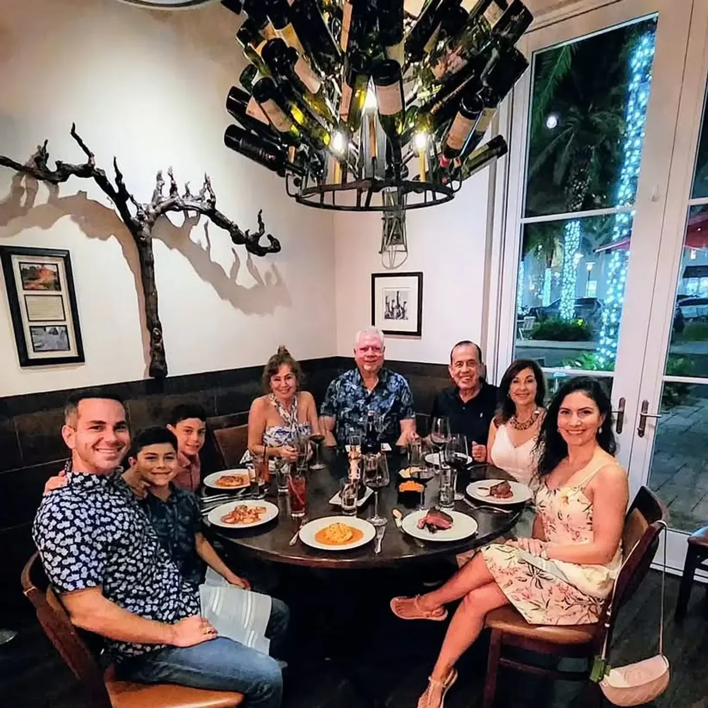 Group dining at Cuvee 30A restaurant in Florida Panhandle with wine and plates