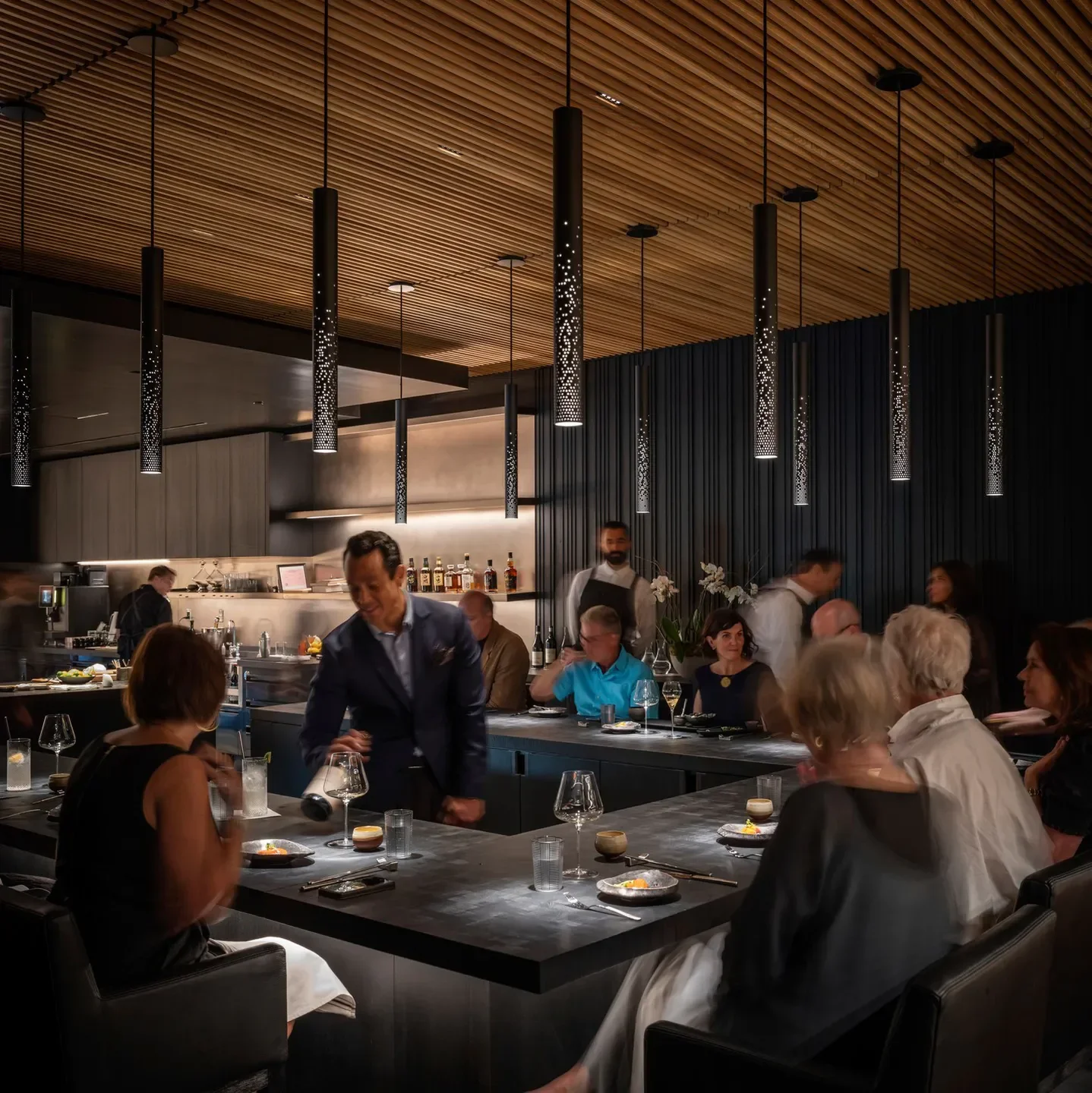 Stylish interior of Cyrus restaurant in Sonoma, with diners and bar service.