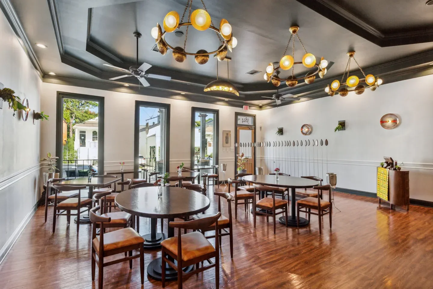 Interior of Dakar NOLA restaurant in New Orleans, featuring stylish tables and decor.