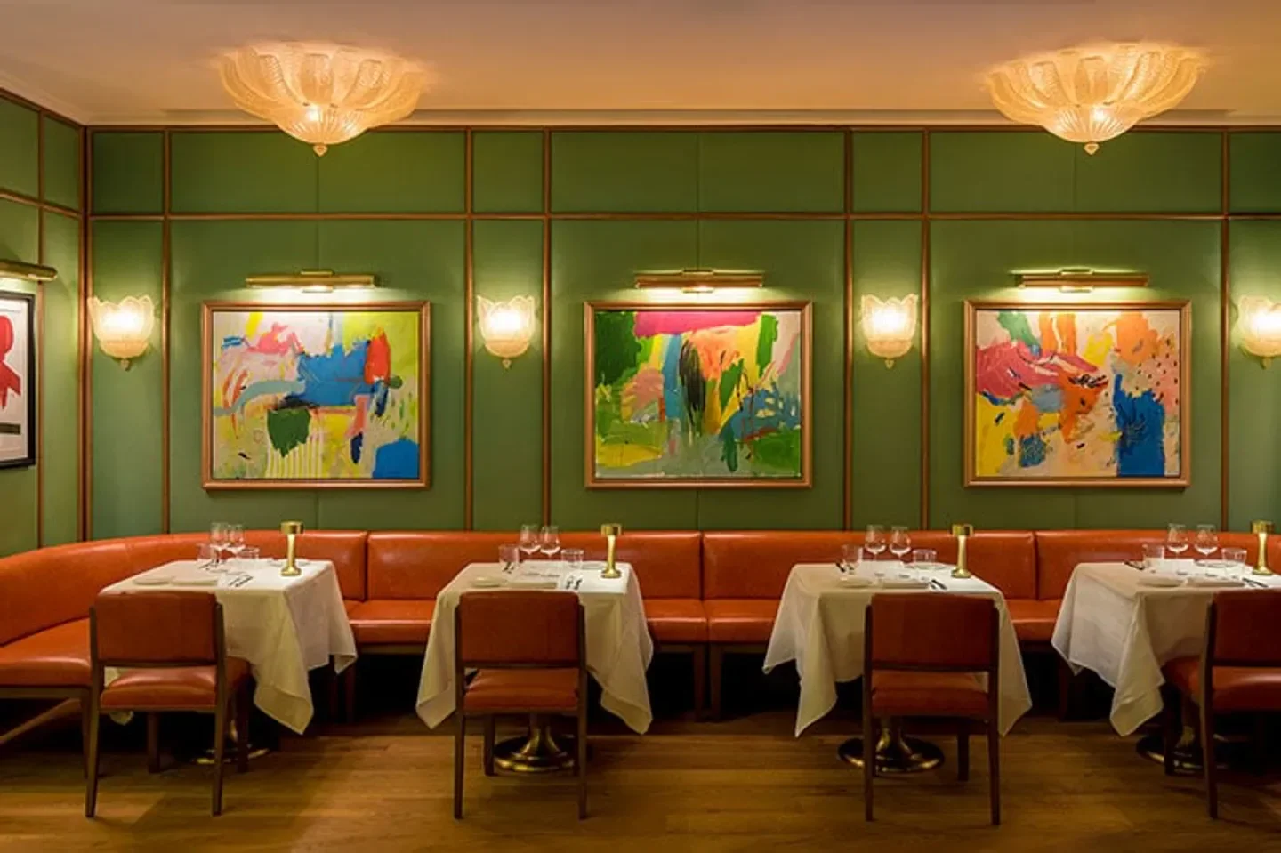 Interior of Dani Brasserie in Madrid with tables, art, and stylish decor.