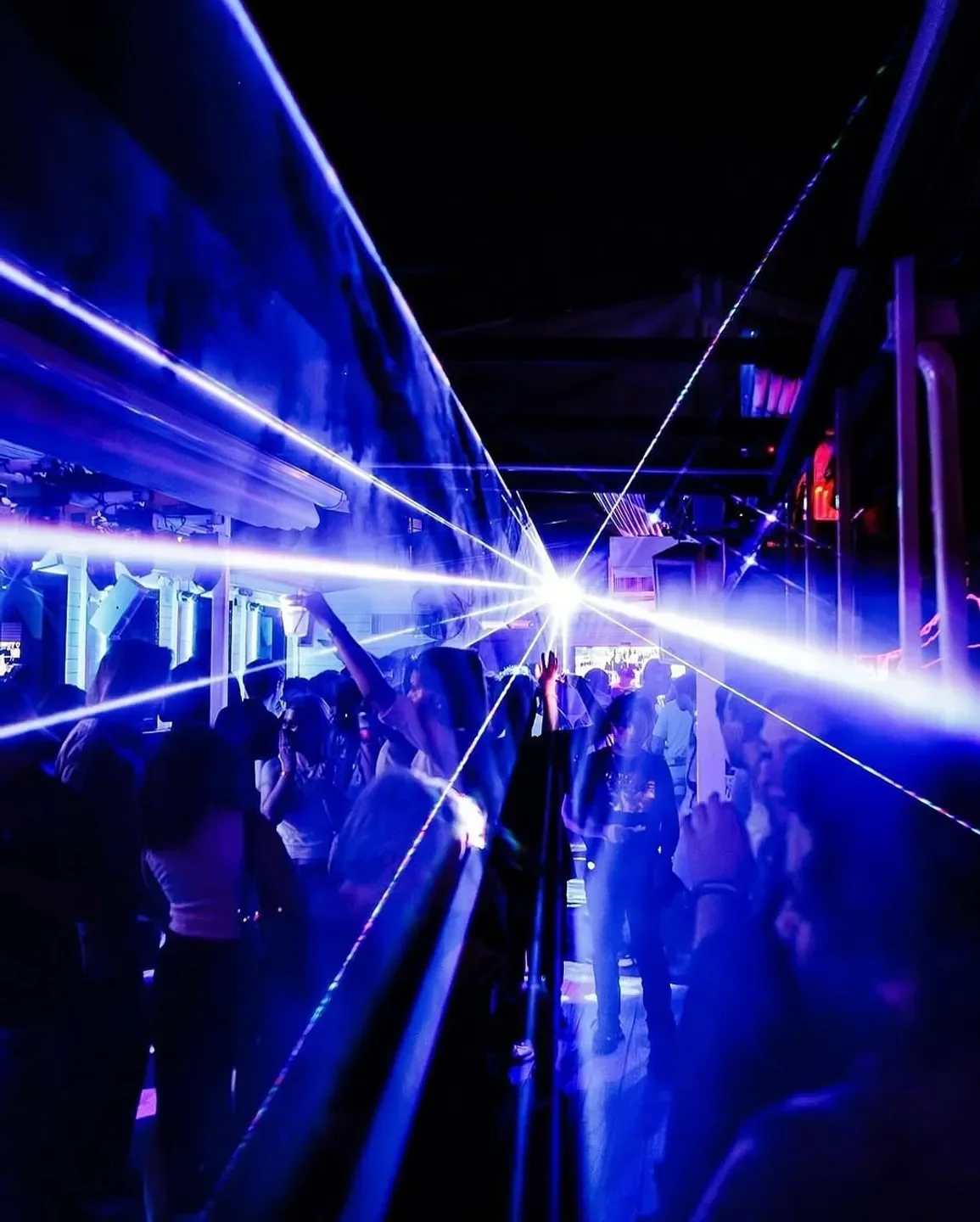 Nightclub scene at Decades DC in Washington with laser lights and partygoers.