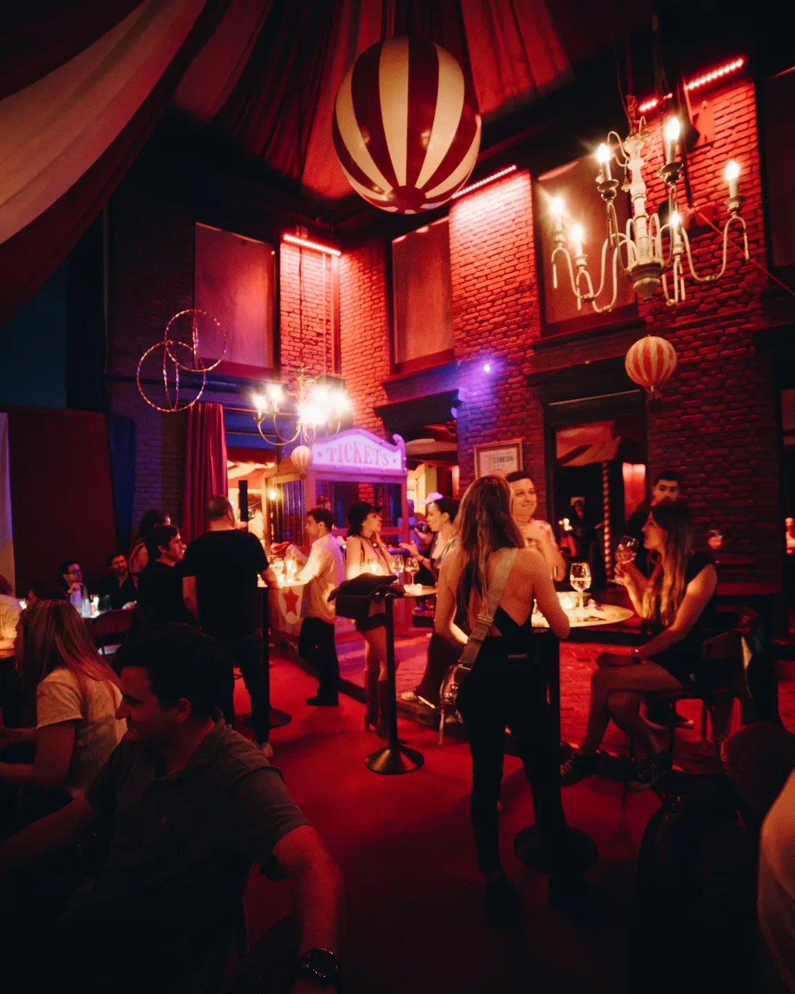 Inside Demencia restaurant in Santiago, Chile, with red lighting and a lively atmosphere.