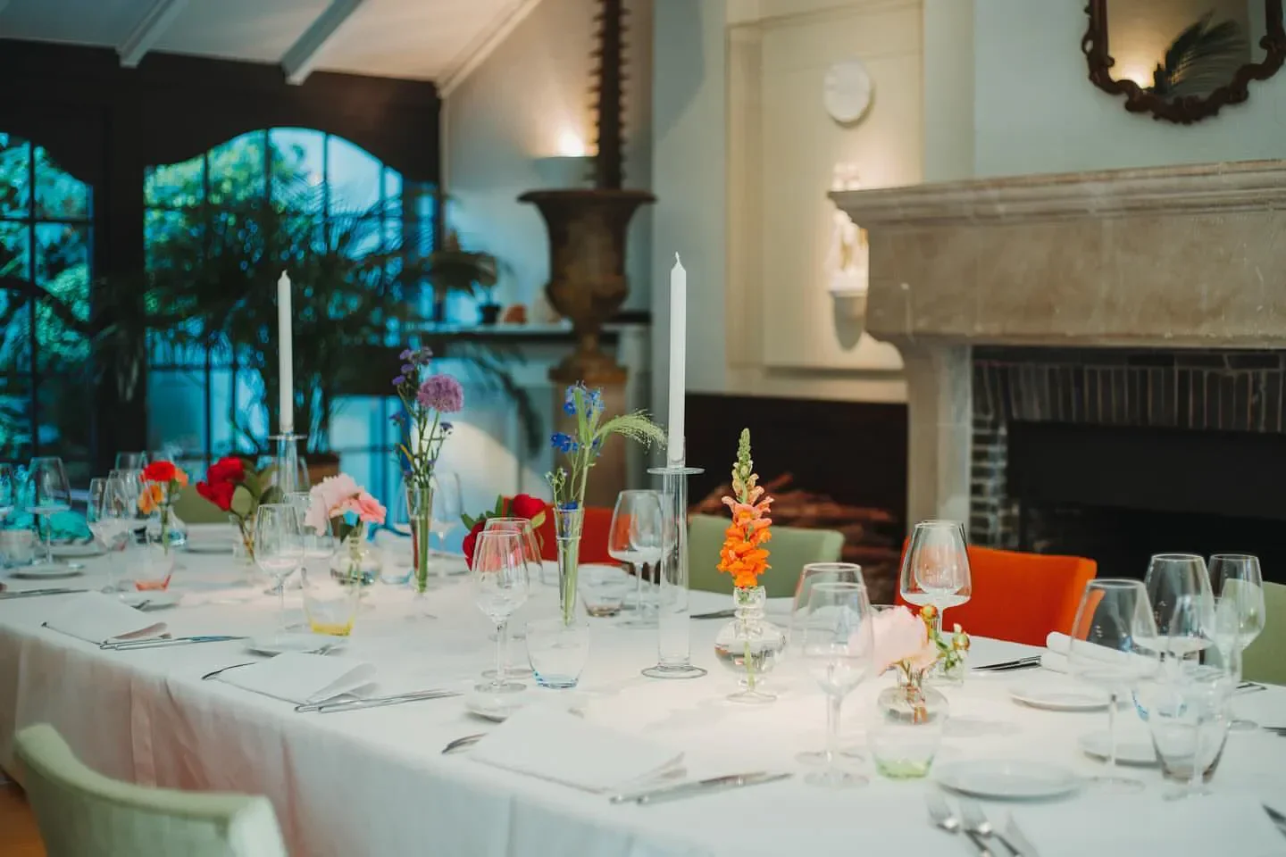 Elegant dining at Den Gouden Harynck restaurant in Bruges, with floral table setting.