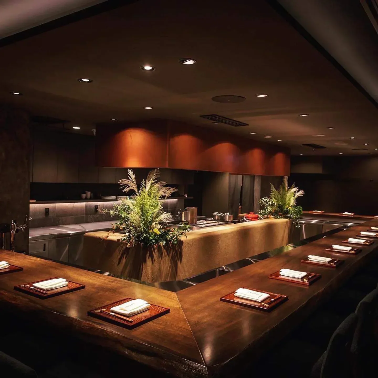 Interior view of DEN KUSHI FLORI restaurant in Tokyo, featuring wooden bar and decor