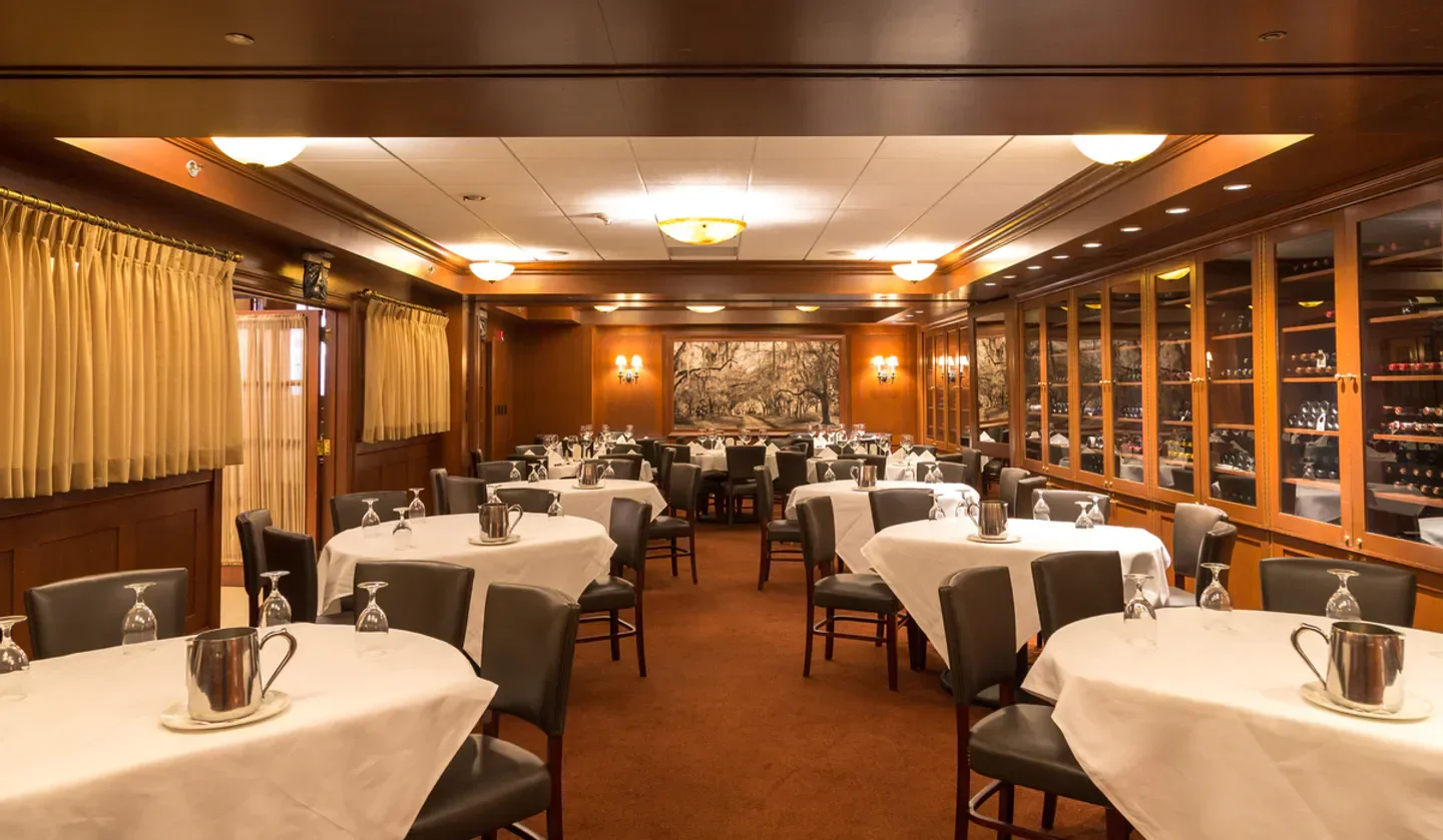 Elegant dining room at Dickie Brennan's Steakhouse in New Orleans with tables set for service.