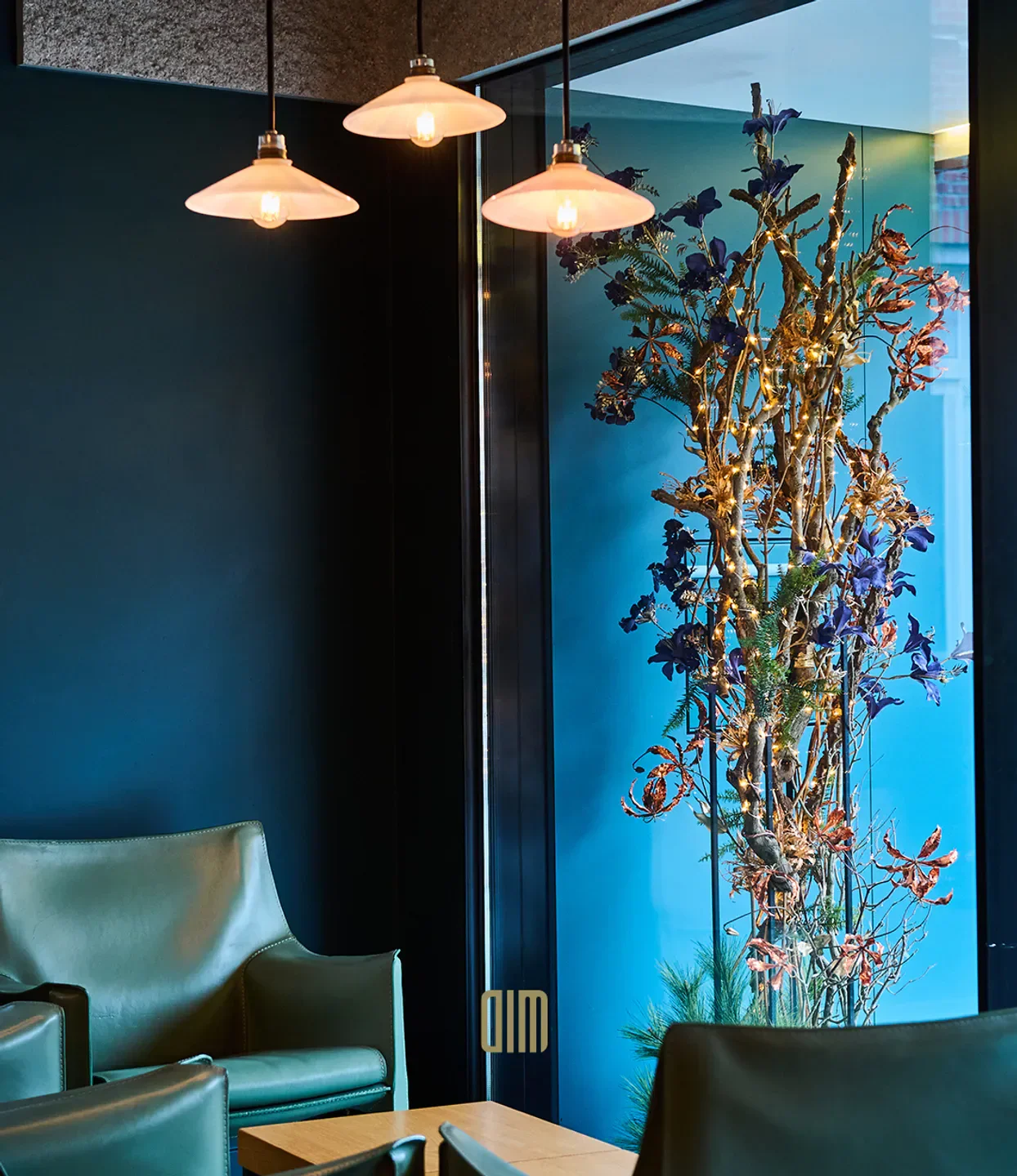 Interior of DIM Dining in Antwerp, featuring stylish decor and floral arrangement.