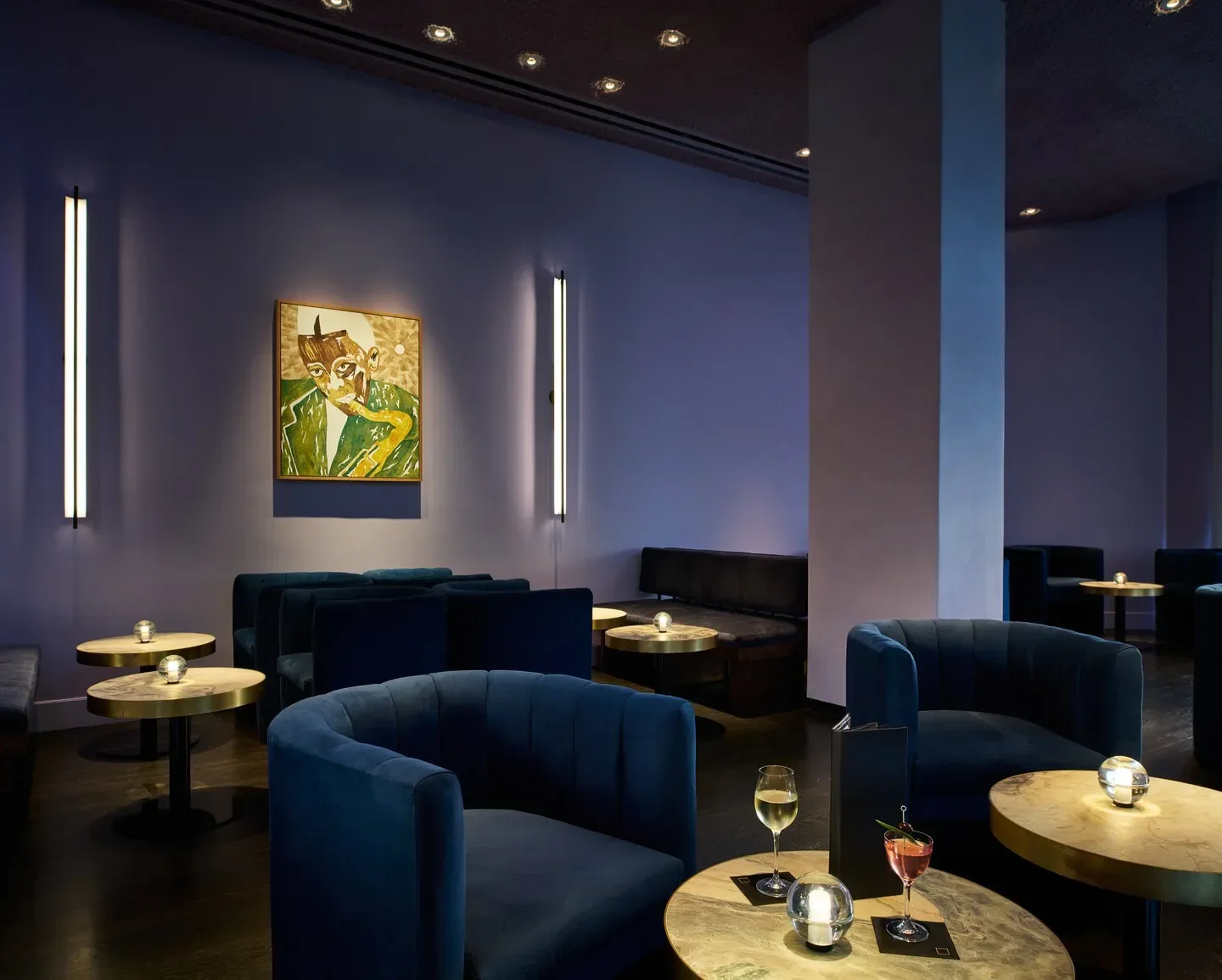 Elegant interior of Dōgon by Kwame Onwuachi, Washington, featuring plush seating and artwork.