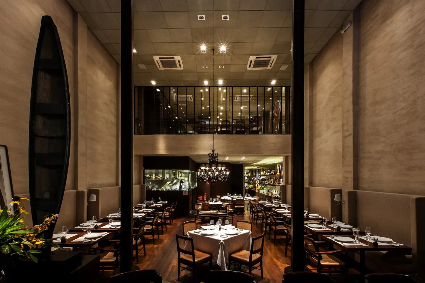 Interior of D.O.M restaurant in Sao Paulo, featuring dining tables and a unique design.