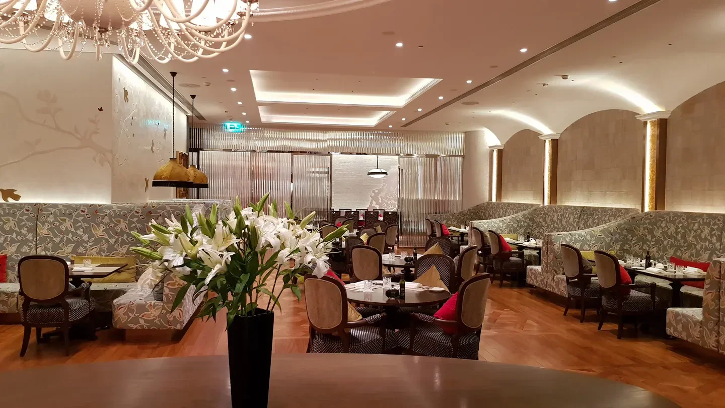 Elegant interior of Don Alfonso 1890 restaurant in Macau, featuring floral decor and refined seating