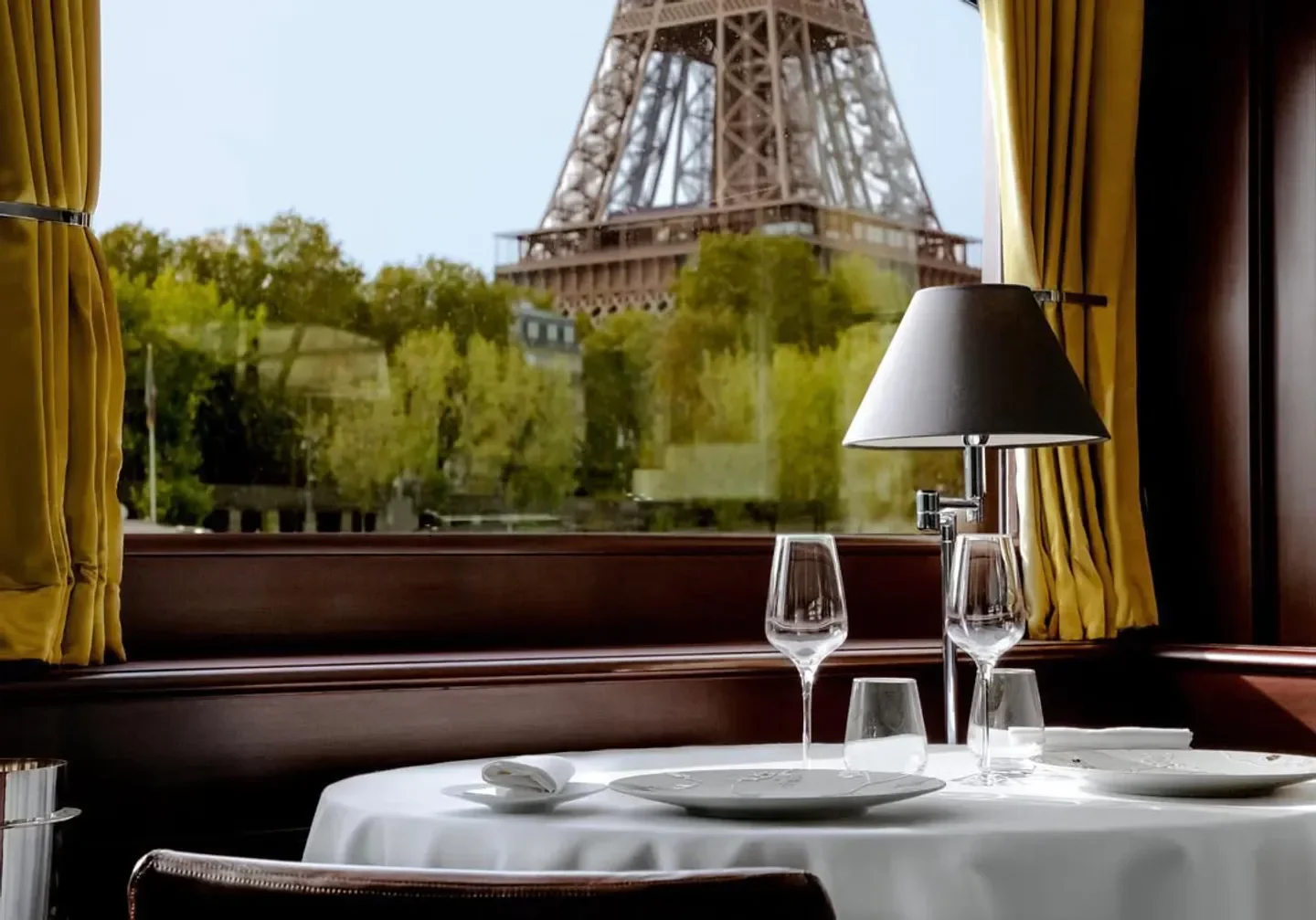 Dining at Don Juan II in Paris with Eiffel Tower view and elegant table setting.