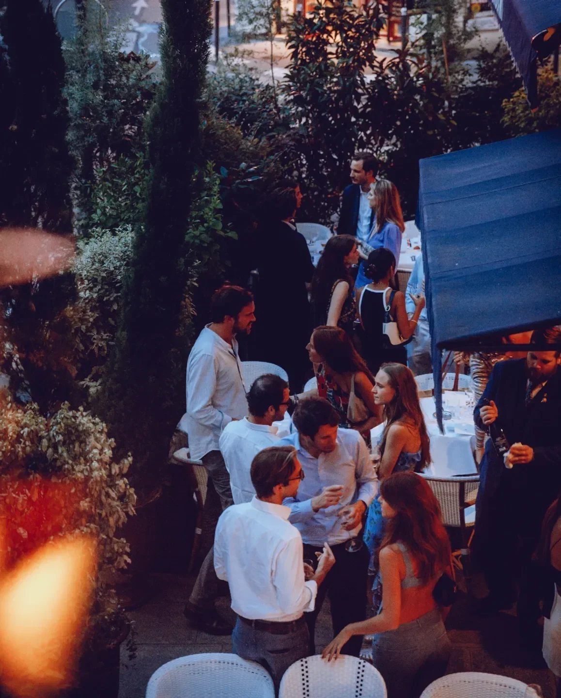 Outdoor gathering at Drouant restaurant in Paris, featuring stylish guests and ambiance.