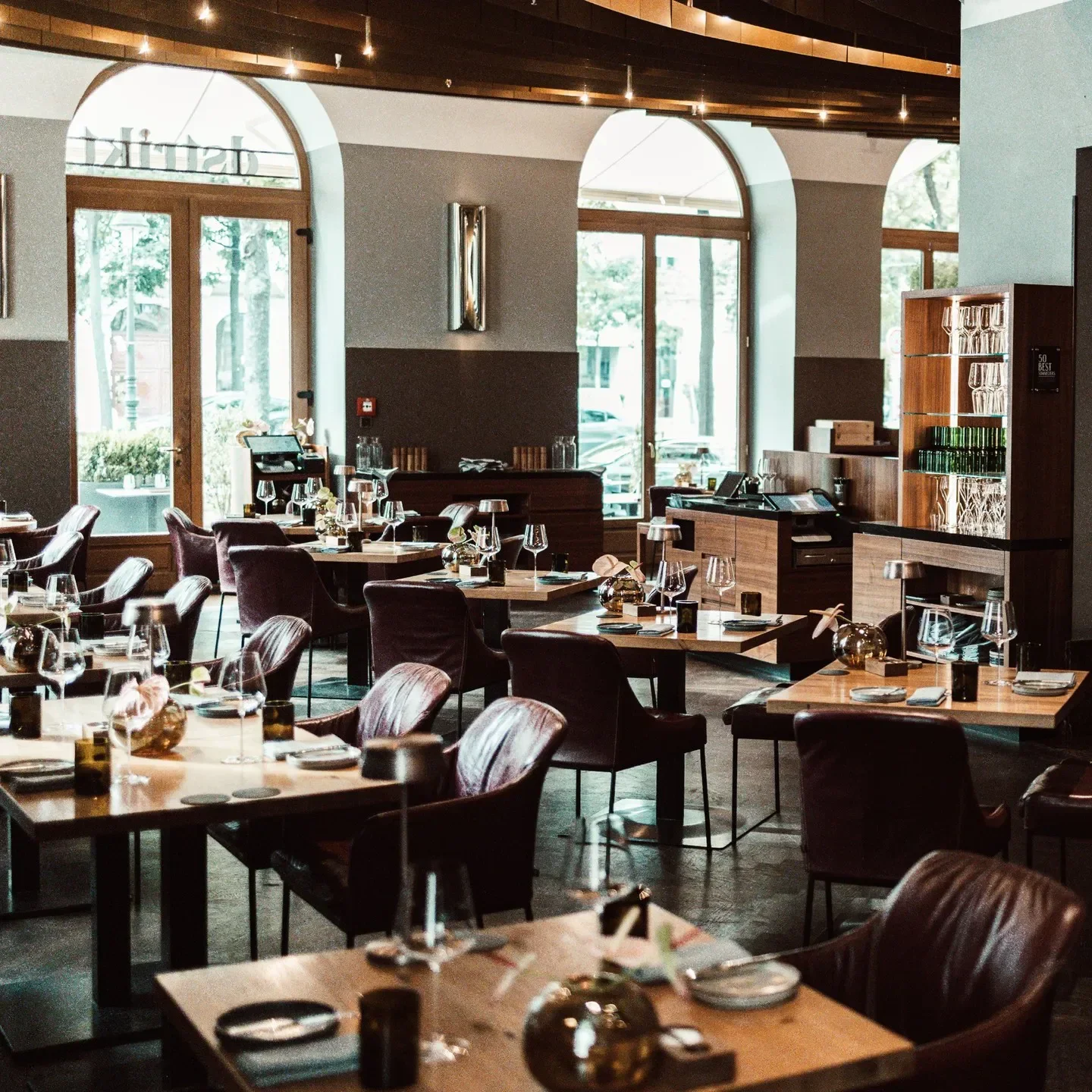 Interior of Dstrikt Steakhouse in Vienna, showing tables, chairs, and elegant decor.