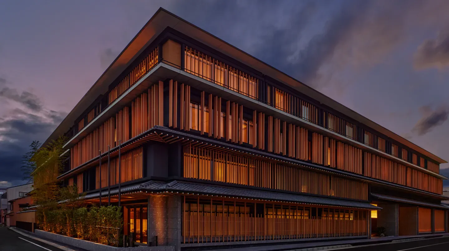 Exterior view of the Dusit Thani Kyoto hotel, illuminated at dusk in Kyoto, Japan.