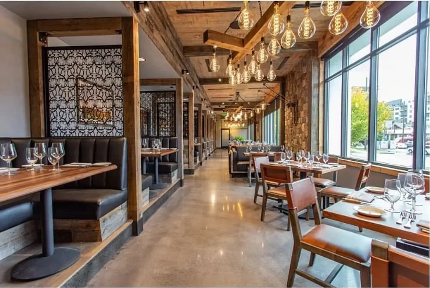 Elegant dining area at E3 Chophouse in Nashville, featuring wood and leather design.