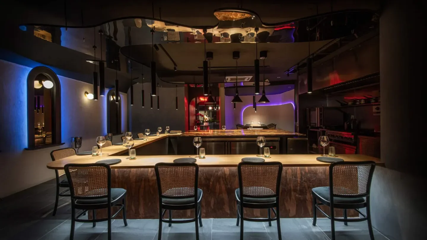 Interior of Eat and Cook in Kuala Lumpur, featuring a stylish dining area with chairs.