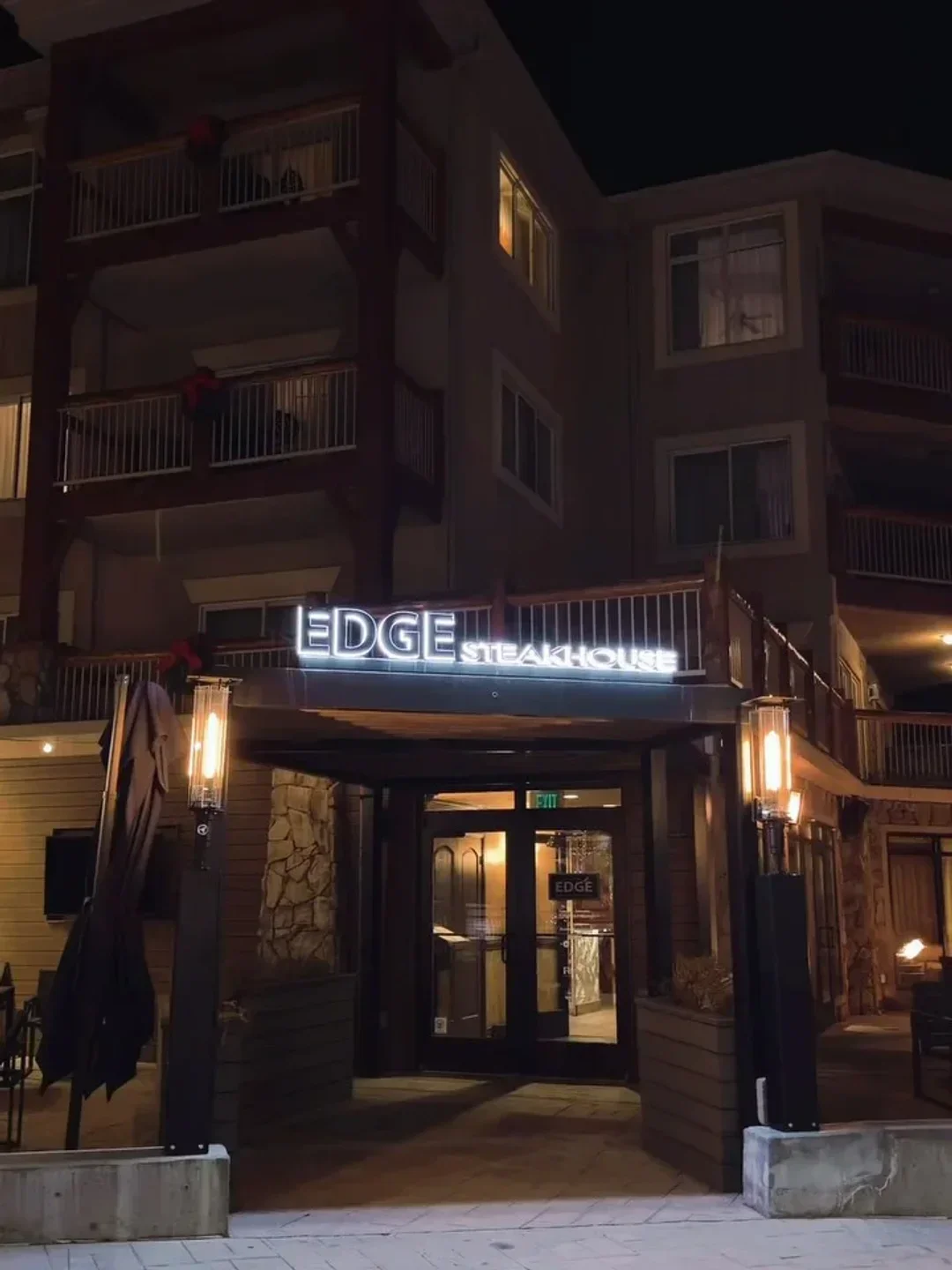 Entrance to Edge Steakhouse in Park City, illuminated at night with exterior lighting