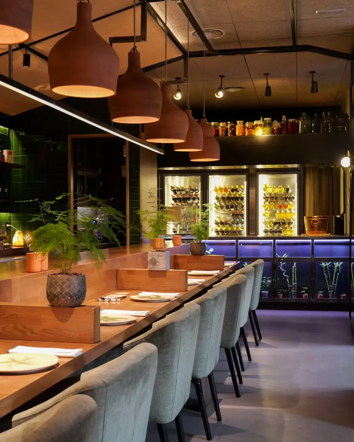 Elegant dining interior at El Invernadero restaurant in Madrid with stylish lighting.