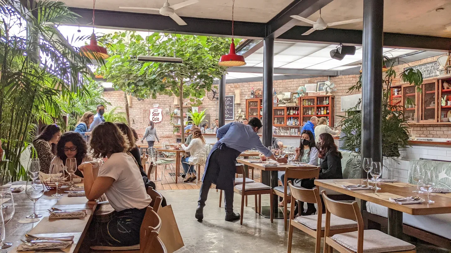 Dining scene at El Mercado restaurant in Lima, Peru, featuring indoor/outdoor setting.