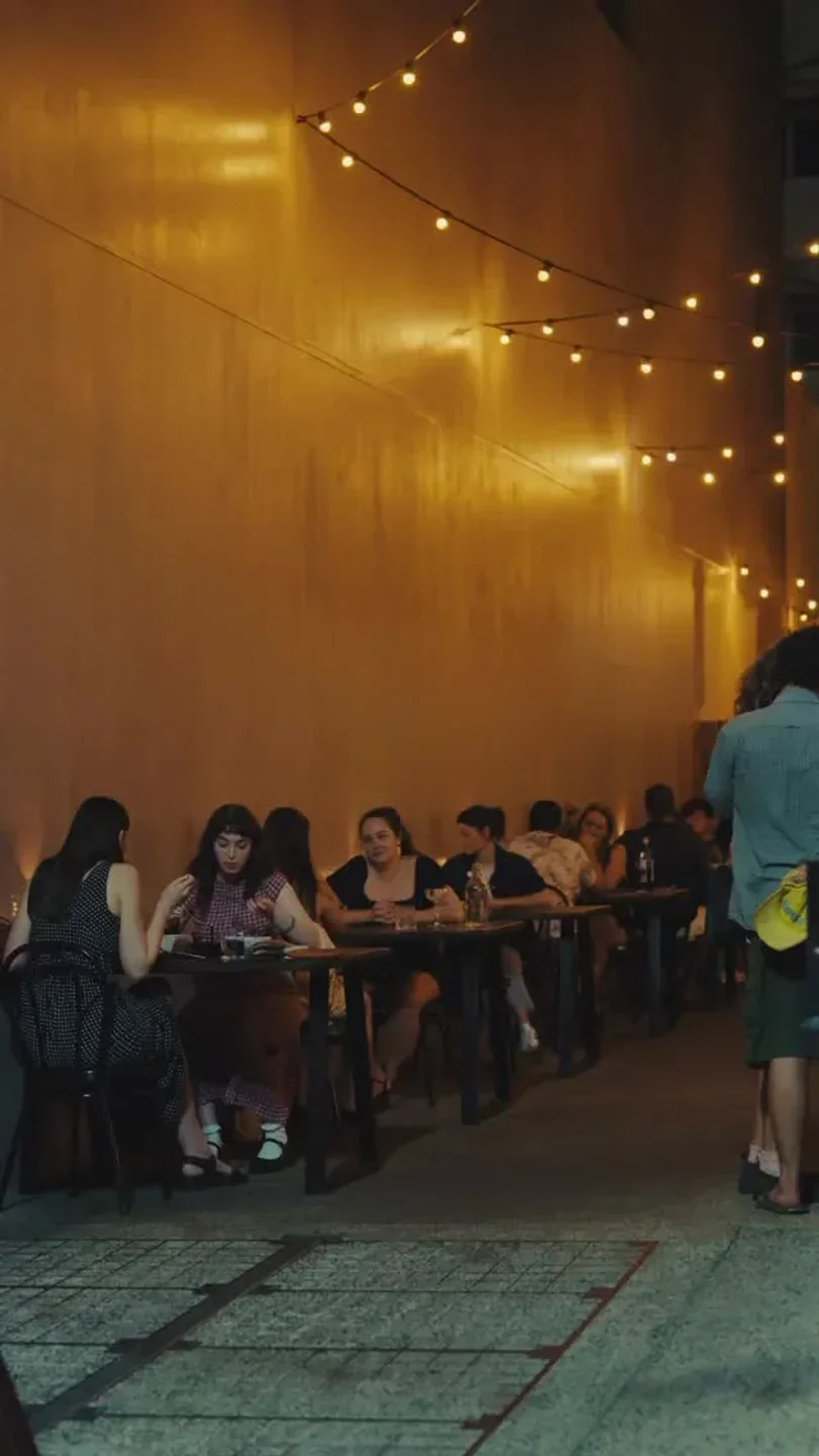 Dining at Ella by Minoli in Darwin, lit with string lights for a cozy atmosphere.