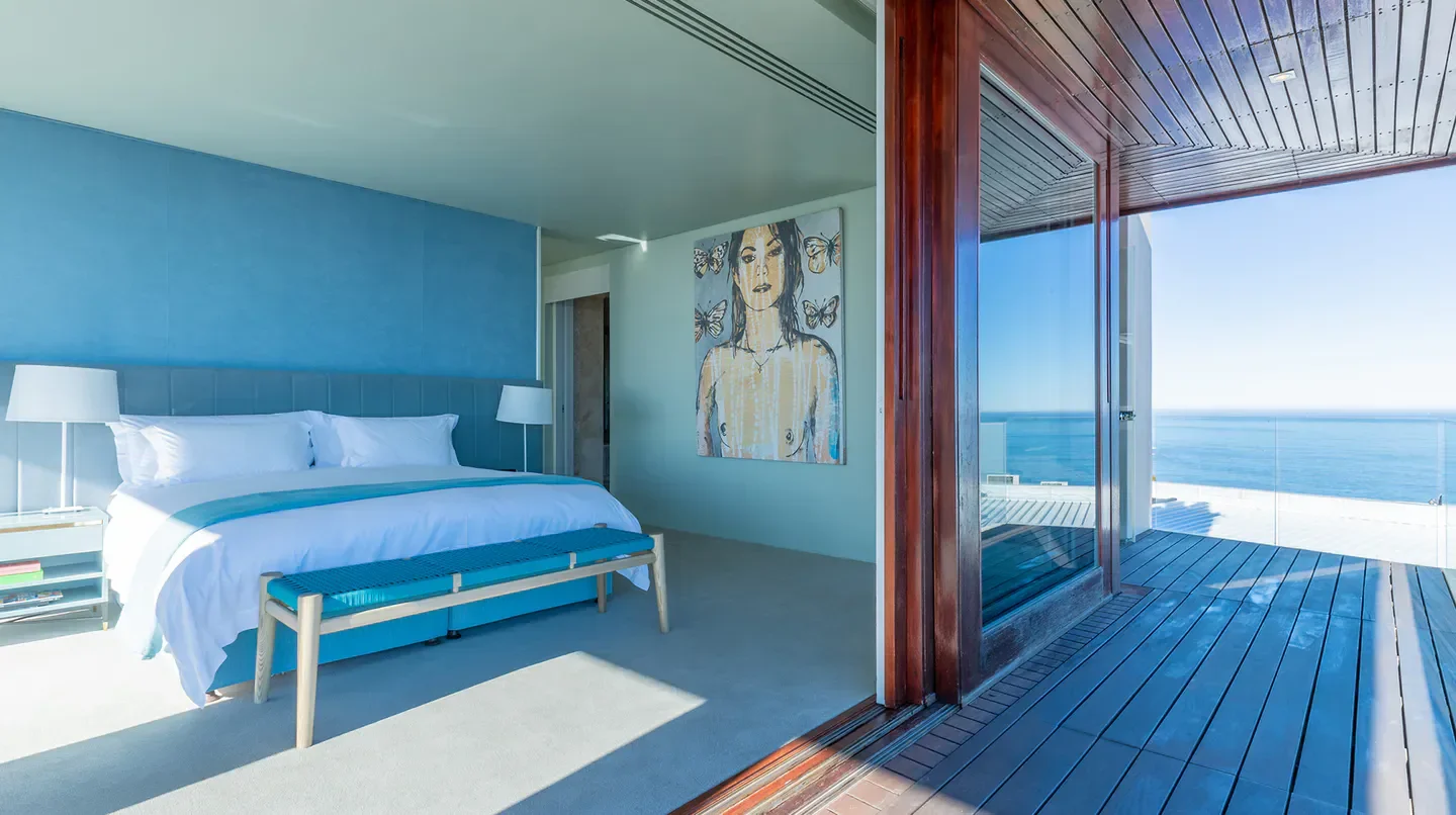 Stylish bedroom with ocean views at Ellerman House in Cape Town, South Africa.