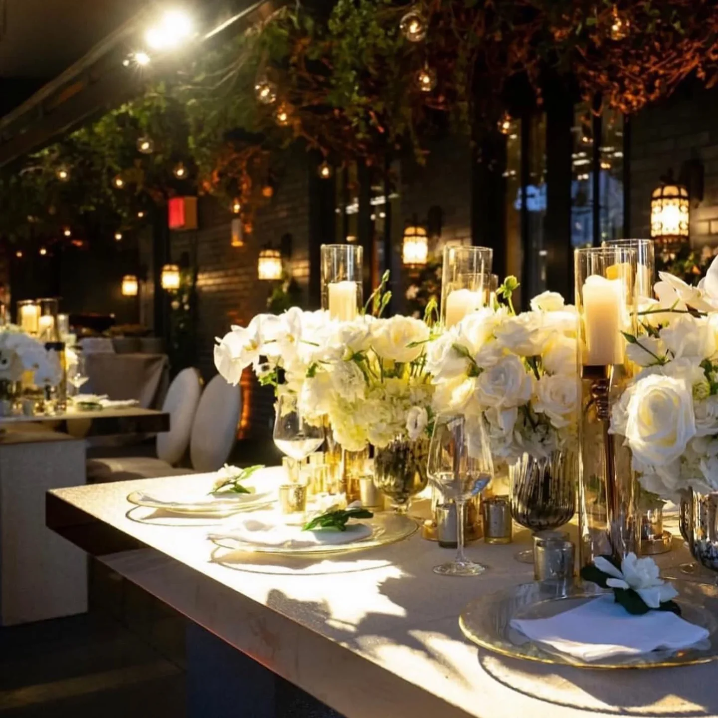 Elsie Rooftop New York City elegant table setting with white flowers and candles