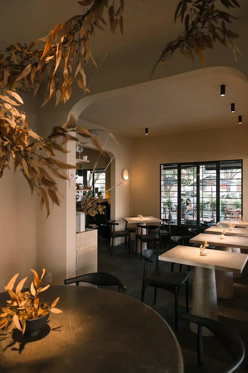 Interior of Em restaurant in Mexico City with stylish tables and decor.