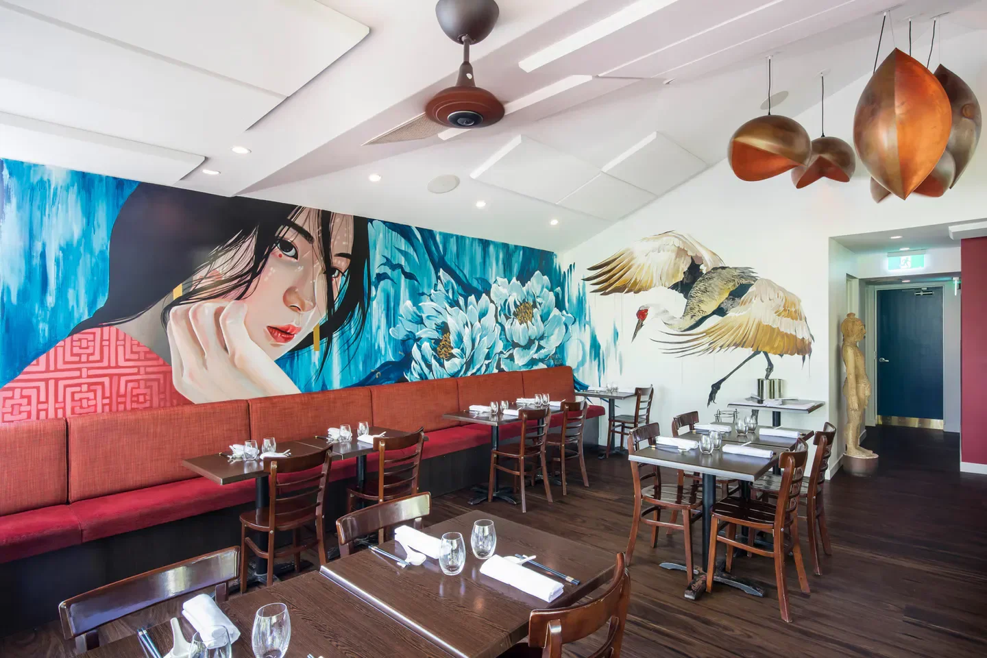 Interior of Embassy XO restaurant on the Sunshine Coast featuring art and dining tables.