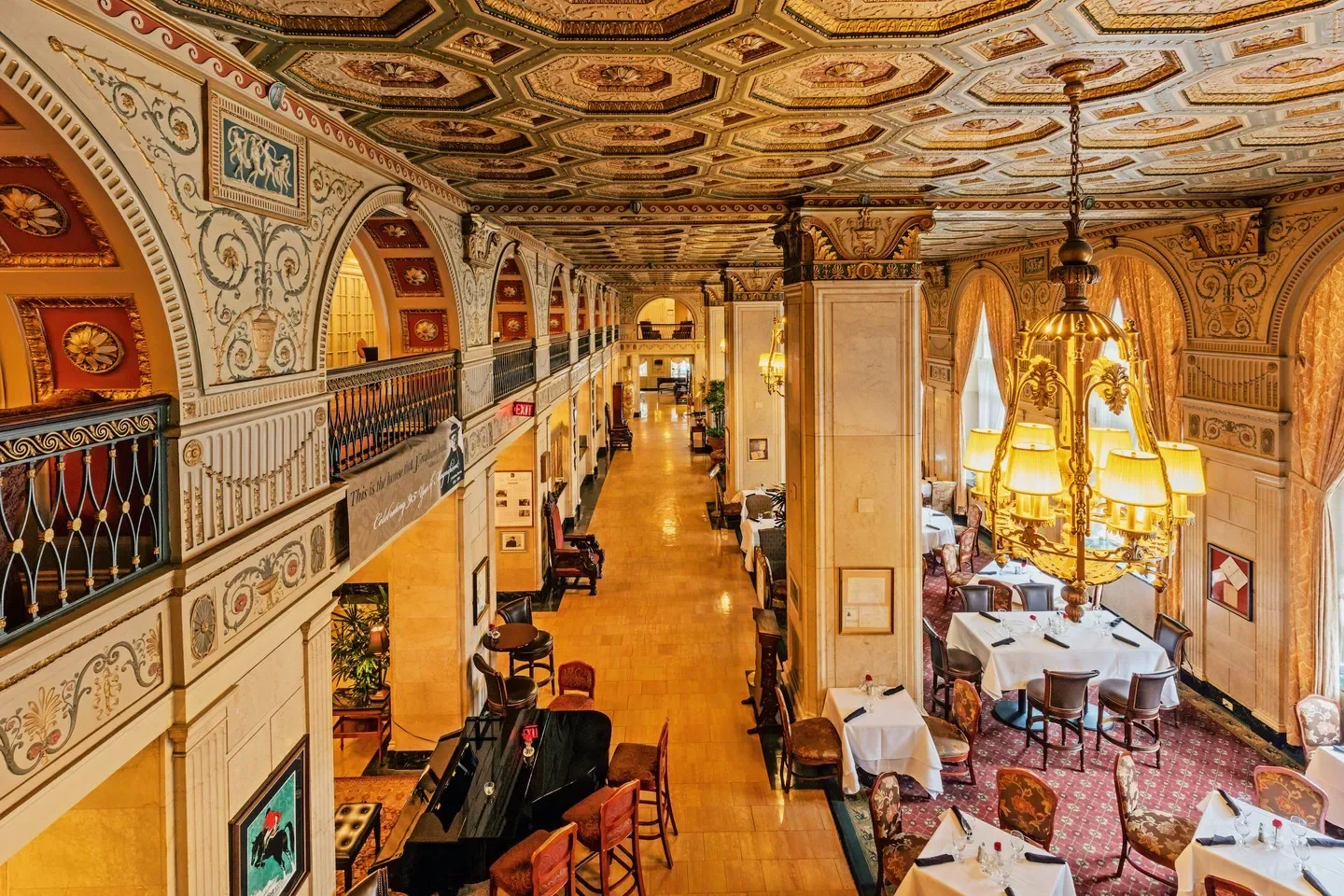 Elegant interior of English Grill restaurant in Louisville, featuring ornate architecture and chandeliers.