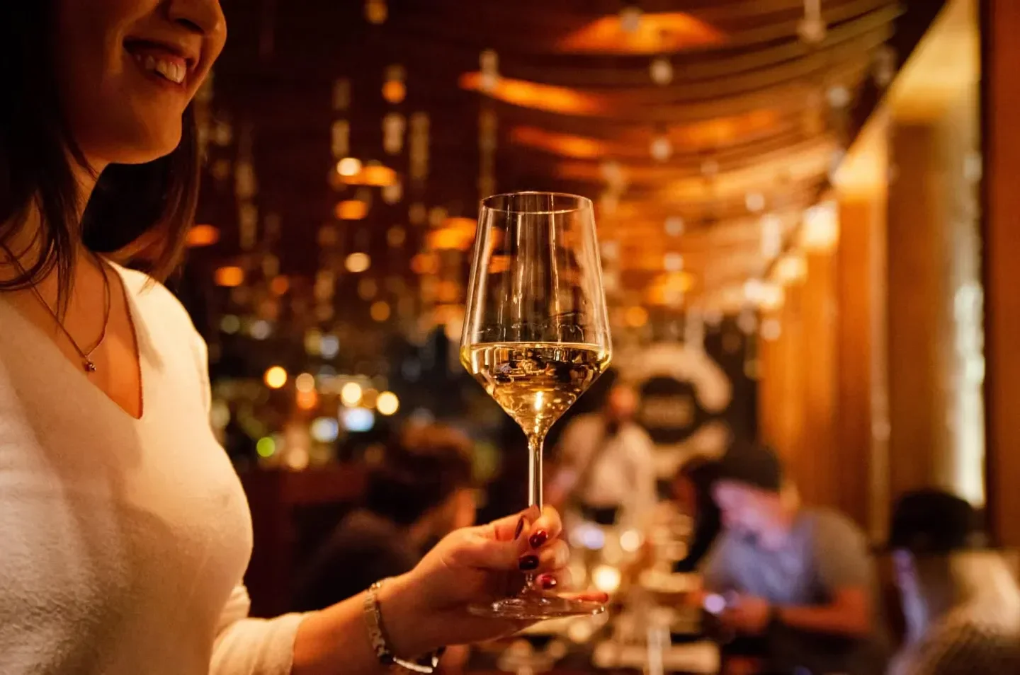 Elegant dining experience at Enso Belgrade, featuring a glass of wine.