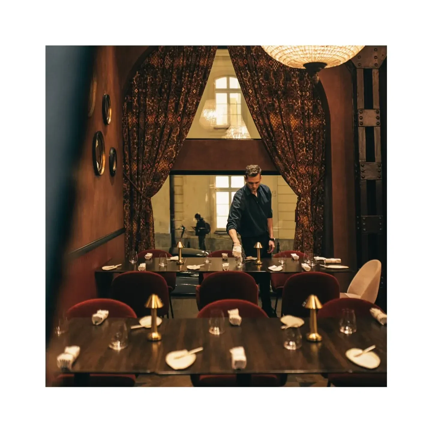 Interior of Epoka restaurant in Warsaw, Poland. Elegant dining area with warm lighting.