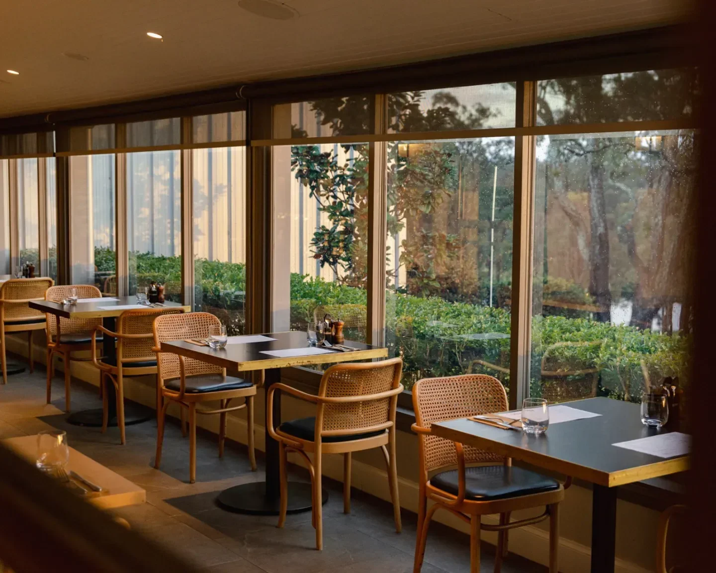 Interior view of éRemo Restaurant in Hunter Valley, showing tables by a large window.