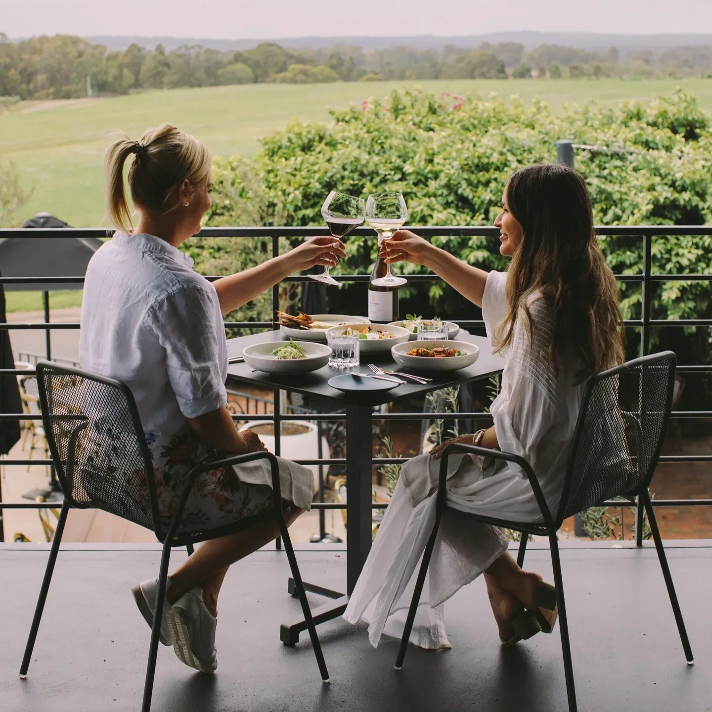 Cheers at Esca Bimbadgen in Hunter Valley: Friends enjoying wine with a beautiful view.