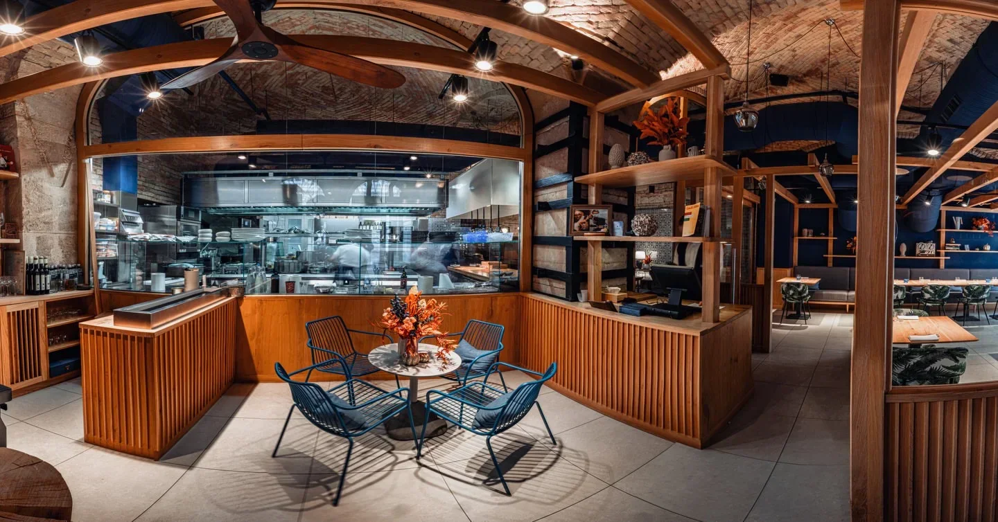 Interior of essência restaurant in Budapest, showing a stylish dining space and open kitchen.
