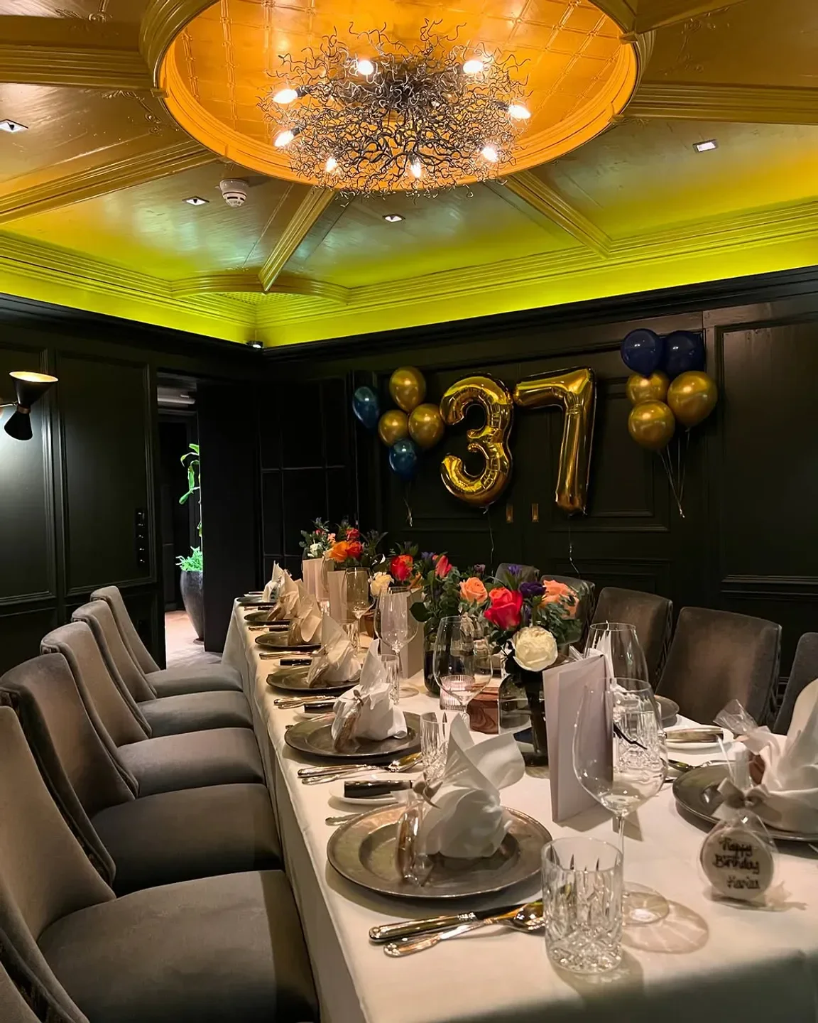 Birthday celebration at EssZimmer Munich, with decorated table and elegant dining setting.