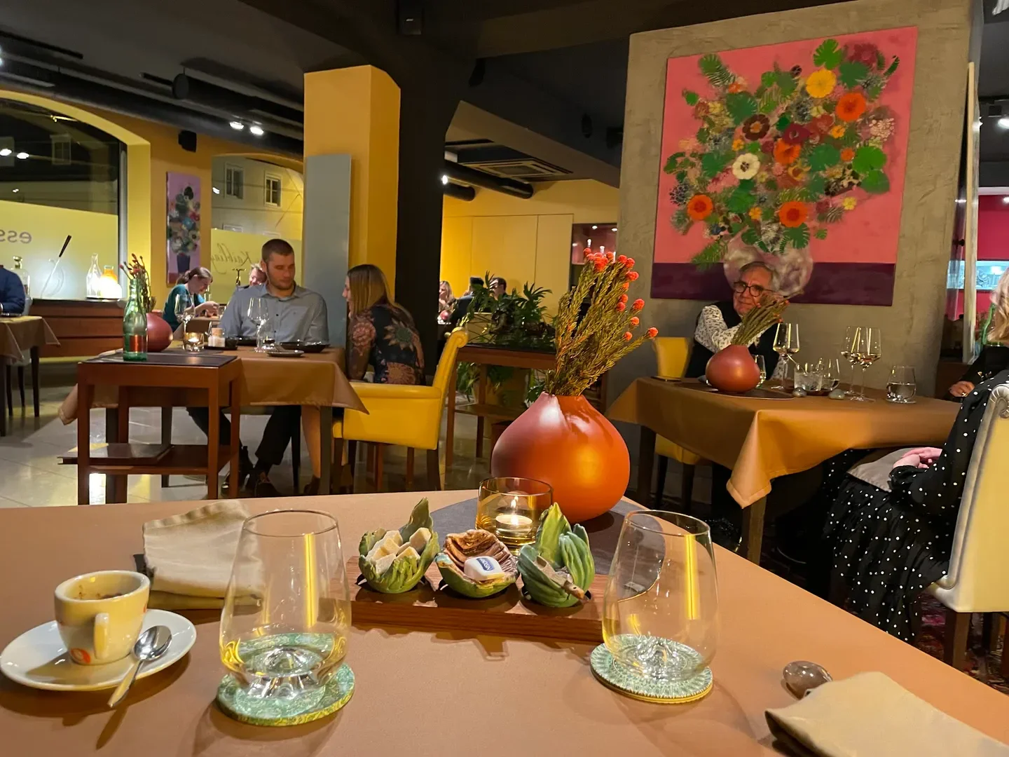 Cozy dining experience at Esszimmer in Salzburg. Featuring elegant table settings and patrons.