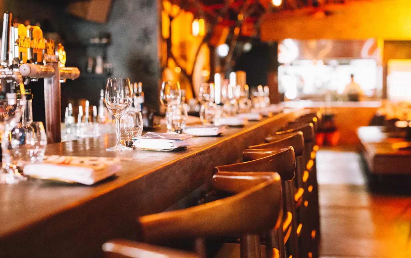Interior bar at Etsu Izakaya Gold Coast, featuring elegant glasses and warm lighting