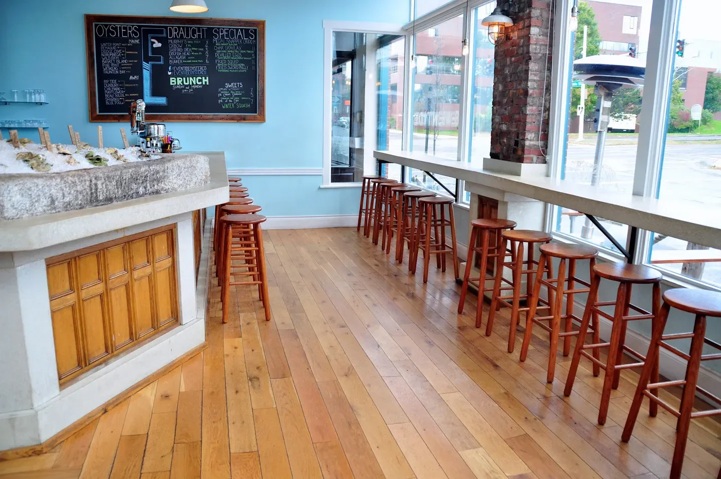 Interior of Eventide Oyster Co in Portland, Maine, showcasing seating and oyster bar.