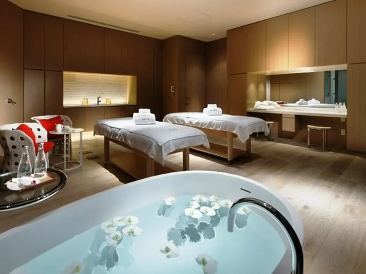 Evian Spa at Palace Hotel Tokyo in Tokyo, featuring massage beds and a relaxing bath.