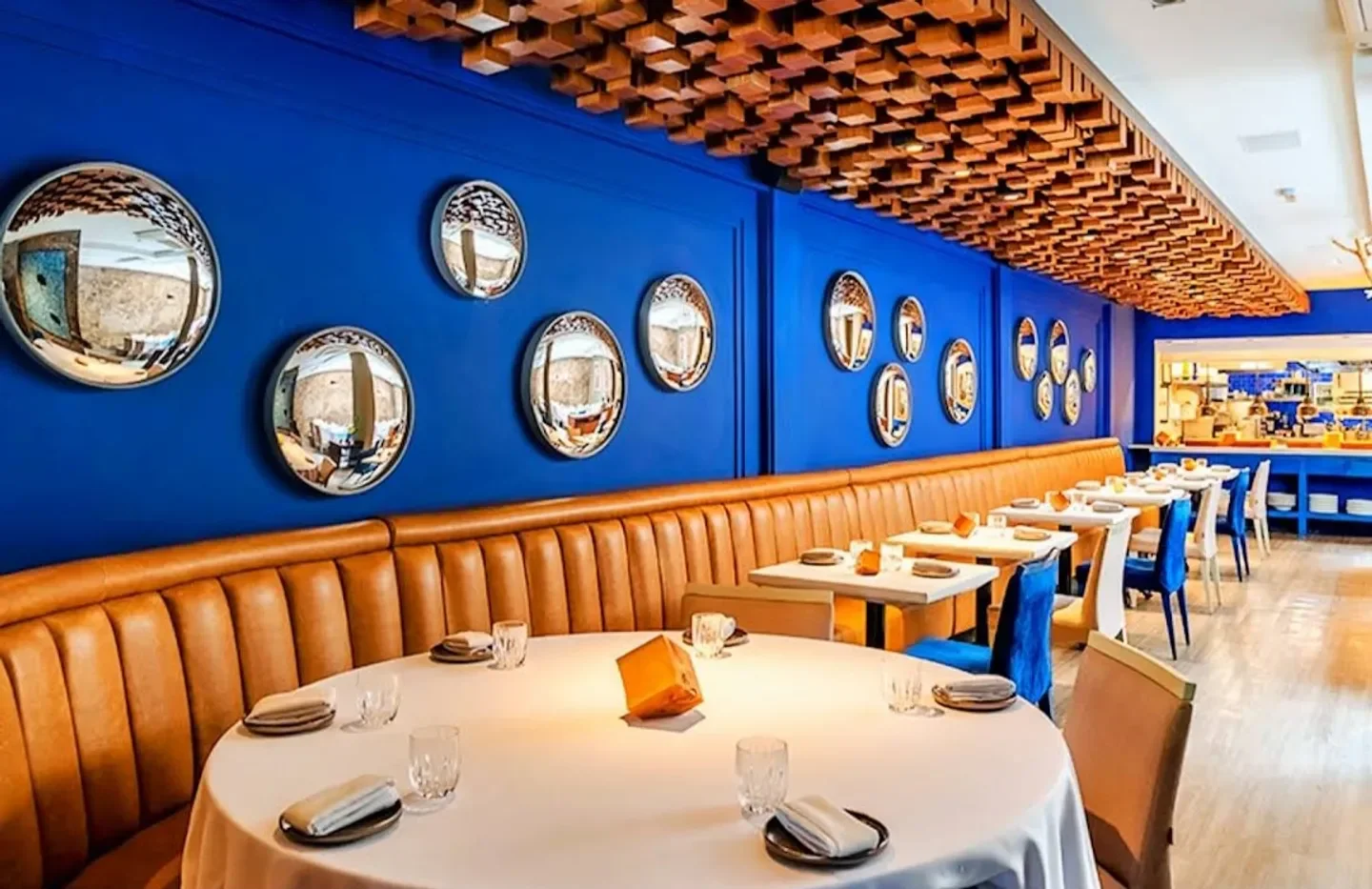 Interior of Evvai restaurant in Sao Paulo, with blue walls and unique decor.