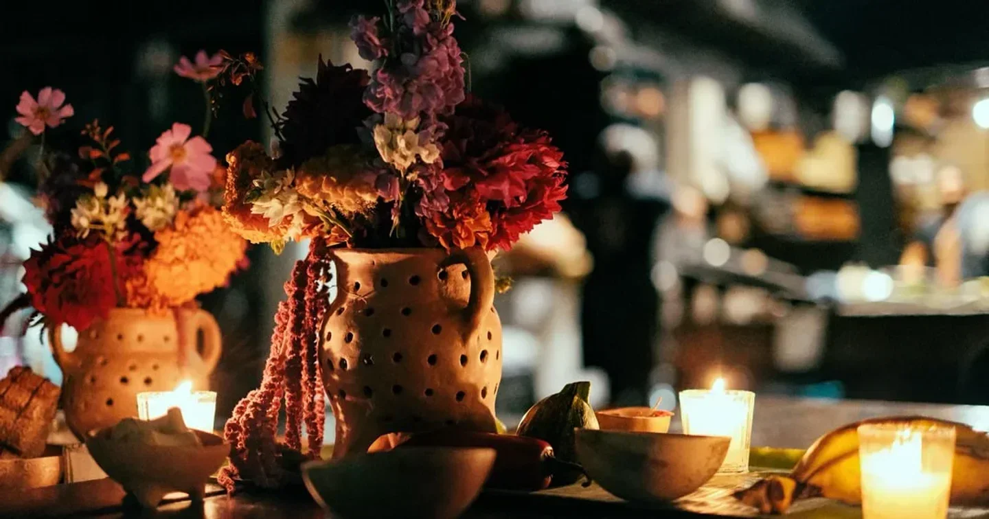 Cozy table setting at Expendio de Maíz restaurant in Mexico City with flowers and candles.
