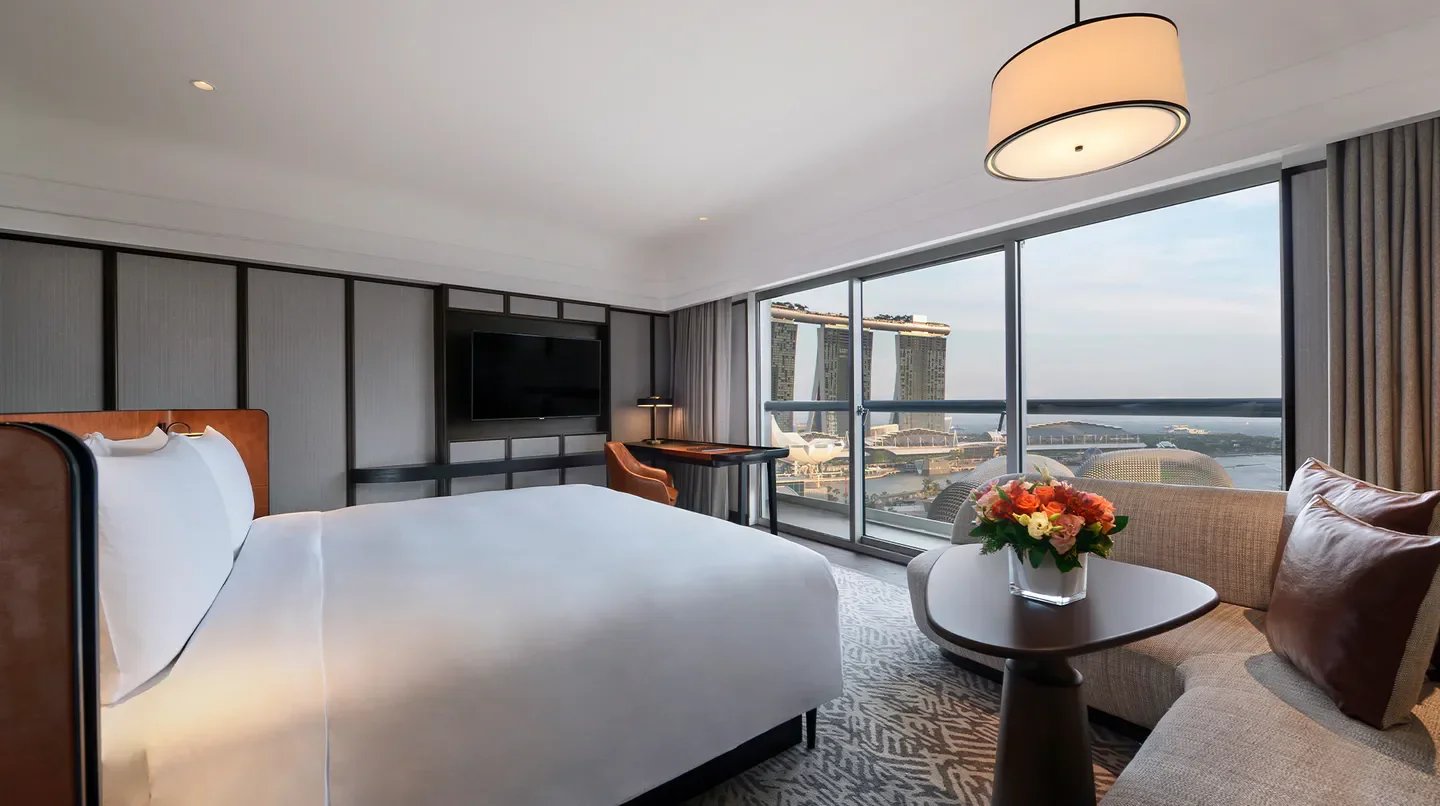 Luxury hotel room at Fairmont Singapore with stunning views of Singapore skyline.